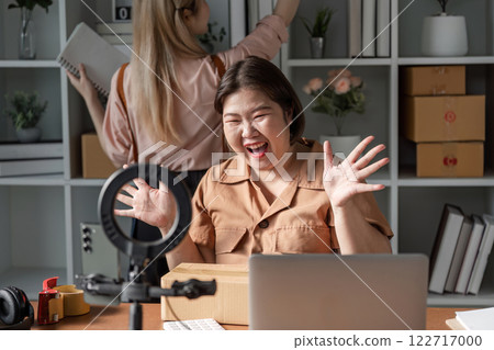 Content creator engaging with followers during a live unboxing session in a chic home office 122717000