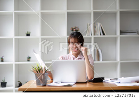 Successful Asian businesswoman dealing with business, finance, and business calculations in the office Successful Asian businesswoman dealing with business, finance, and business calculations in the office 122717012