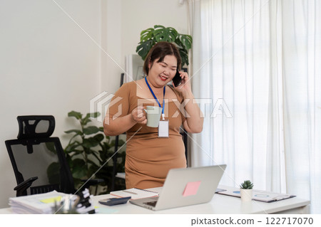 Confident Businesswoman Engaging in a Lively Work Discussion While Enjoying a Coffee Break in a Modern Office Setting Confident Businesswoman Engaging in a Lively Work Discussion While Enjoying a Coffee Break in a Modern Office Setting 122717070