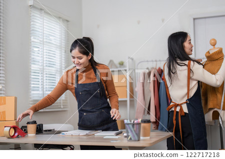 Fashion designers collaborating creatively in a modern studio with tools and unique garments Fashion designers collaborating creatively in a modern studio with tools and unique garments 122717218