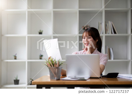 Successful Asian businesswoman dealing with business, finance, and business calculations in the office 122717237