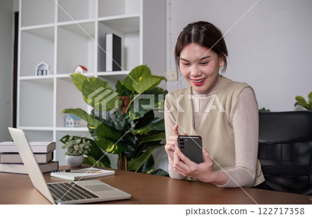Asian college student sit at home studying online using a video calling program on their laptop. 122717358