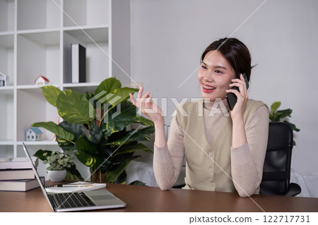 Asian college student sit at home studying online using a video calling program on their laptop. Asian college student sit at home studying online using a video calling program on their laptop. 122717731