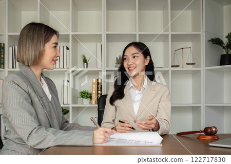 Lawyer and businesswomen discussing and introducing Providing legal advice regarding signing insurance contracts or financial contracts Lawyer and businesswomen discussing and introducing Providing legal advice regarding signing insurance contracts or financial contracts 122717830