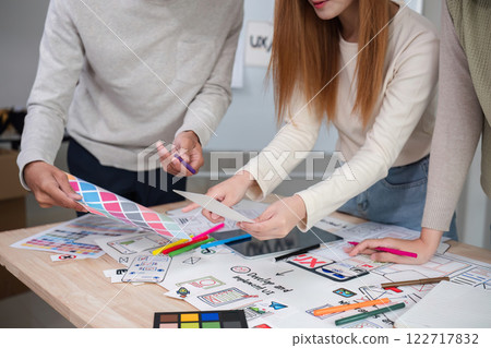 Creative designer team meeting on application design and ux ui usability planning. business team teamwork. Creative designer team meeting on application design and ux ui usability planning. business team teamwork. 122717832
