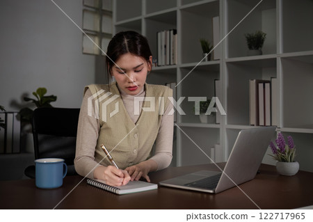 Asian female student studying online Video calls through Zoom about business administration and accounting subjects attentively 122717965