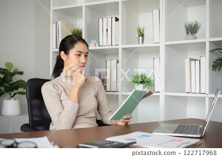 Young Asian student studies online about graphs and statistics. Happy Zoom video call studying with laptop computer 122717968