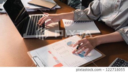 Work performance summary report Asian woman working online and planning financial information with laptop working from home Businesswoman and planner concept 122718055