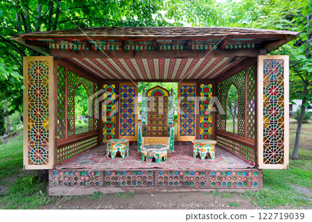 Colorful traditional architectural pavilion near Shaki Khan Palace in Azerbaijan surrounded by lush greenery Colorful traditional architectural pavilion near Shaki Khan Palace in Azerbaijan surrounded by lush greenery 122719039