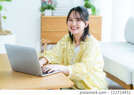 Young woman working on a laptop at home 122719452