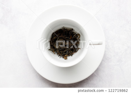 Cup of hot tea with tea leaf on white table background. 122719862