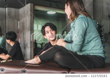 Asian woman consulting a judo therapist for ankle sprain/injury rehabilitation Asian woman consulting a judo therapist for ankle sprain/injury rehabilitation 122720161