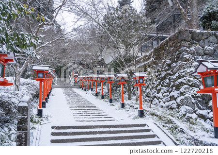 Winter in Kyoto: Kurama Temple, stone steps and lanterns on the winding approach to the temple Winter in Kyoto: Kurama Temple, stone steps and lanterns on the winding approach to the temple 122720218