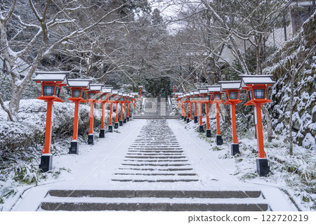 Winter in Kyoto: Kurama Temple, stone steps and lanterns on the winding approach to the temple Winter in Kyoto: Kurama Temple, stone steps and lanterns on the winding approach to the temple 122720219