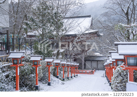 Winter in Kyoto: Kurama Temple, stone steps and lanterns on the winding approach to the temple Winter in Kyoto: Kurama Temple, stone steps and lanterns on the winding approach to the temple 122720223