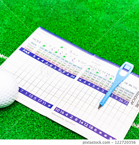 Filling out a golf scorecard [Golf attest image] 122720356