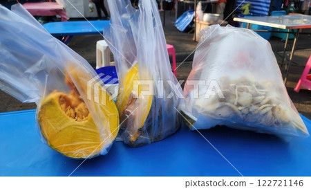 Freshly Packaged Sliced Fruits and Vegetables at Local Market Stall 122721146