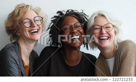Three happy diverse women laughing together celebrating women's achievements 122721233