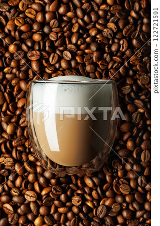 cappuccino in glass and coffee beans as background 122721591