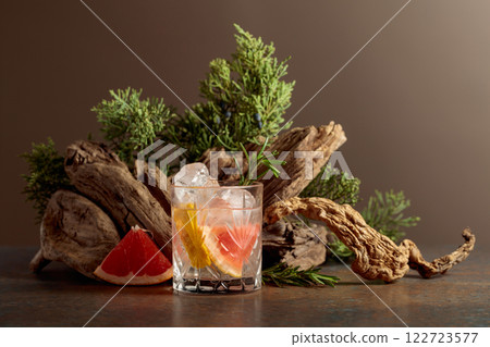 Cocktail: gin and tonic with ice, grapefruit, and rosemary. Cocktail: gin and tonic with ice, grapefruit, and rosemary. 122723577