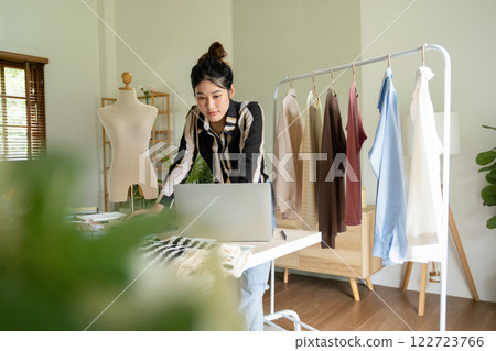 Young clothing designer envisions new ideas in studio. Young clothing designer envisions new ideas in studio. 122723766