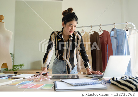 Young clothing designer envisions new ideas in studio. 122723768