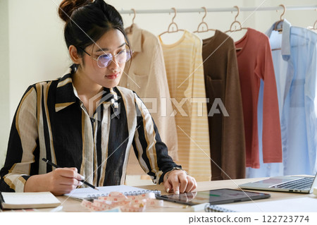 Young clothing designer envisions new ideas in studio. 122723774