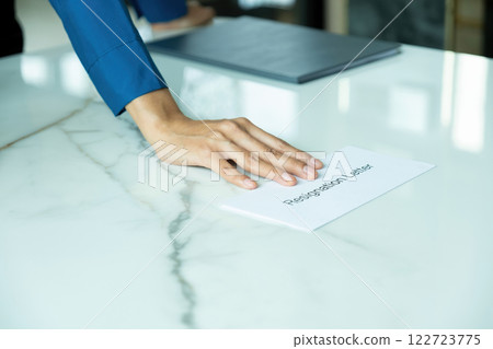 A woman handing resignation letter. A woman handing resignation letter. 122723775