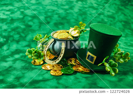St. Patrick's Day Treasures. Green hat with gold coins, lucky clovers, and a pot St. Patrick's Day Treasures. Green hat with gold coins, lucky clovers, and a pot 122724026