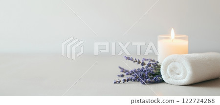 Enhance relaxation with a serene spa offer featuring lavender sprigs, a glowing candle, and a soft towel on a wooden surface Enhance relaxation with a serene spa offer featuring lavender sprigs, a glowing candle, and a soft towel on a wooden surface 122724268