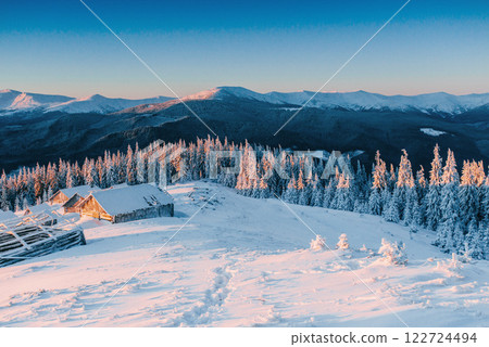 Mysterious winter landscape majestic mountains in winter. Magical winter snow covered tree. Winter road in the mountains. In anticipation of the holiday. Dramatic wintry scene. Carpathian. Ukraine Mysterious winter landscape majestic mountains in winter. Magical winter snow covered tree. Winter road in the mountains. In anticipation of the holiday. Dramatic wintry scene. Carpathian. Ukraine 122724494