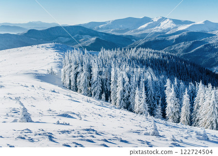 Fantastic winter landscape. Magic sunset in the mountains a frosty day. On the eve of the holiday. The dramatic scene. Carpathian, Ukraine, Europe. Fantastic winter landscape. Magic sunset in the mountains a frosty day. On the eve of the holiday. The dramatic scene. Carpathian, Ukraine, Europe. 122724504