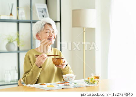 Senior woman drinking miso soup for breakfast Senior woman drinking miso soup for breakfast 122724840