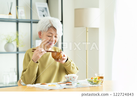 Senior woman drinking miso soup for breakfast 122724843