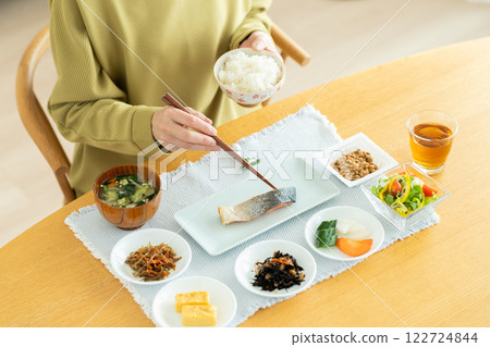 A young woman eating breakfast A young woman eating breakfast 122724844