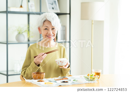 Senior woman eating breakfast Senior woman eating breakfast 122724853