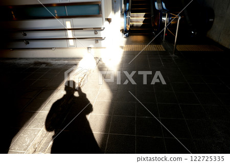Light, shadows, and scalator at the exit of an underground passage Light, shadows, and scalator at the exit of an underground passage 122725335