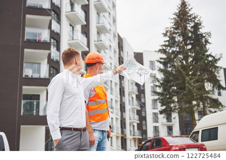business, building, teamwork and people concept - group of smiling builders in hardhats at construction site business, building, teamwork and people concept - group of smiling builders in hardhats at construction site 122725484