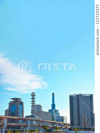 A streetscape of Kobe lined with office buildings and high-rise apartment buildings 122725875