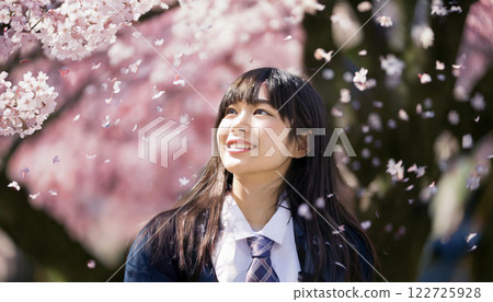 A high school girl looking up at cherry blossoms. A high school girl looking up at cherry blossoms. 122725928
