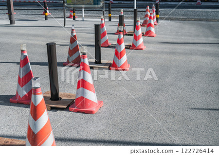 Car stop pole installed on the sidewalk 122726414