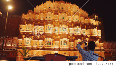 Jaipur, Rajasthan, India. Hawa Mahal Palace In Night Illuminations. Tourist Takes Photo Of Palace. Palace Of Winds. Built From Red And Pink Sandstone. Maharaja Sawai Pratap Singh Built Palace In 1799 122726433