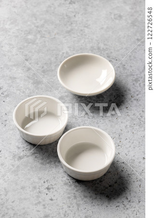 empty clean bowls on grey background empty clean bowls on grey background 122726548