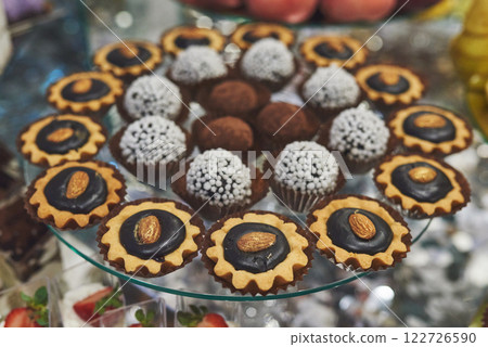 delicious colorful cookies and cakes on the wedding candy bar. 122726590