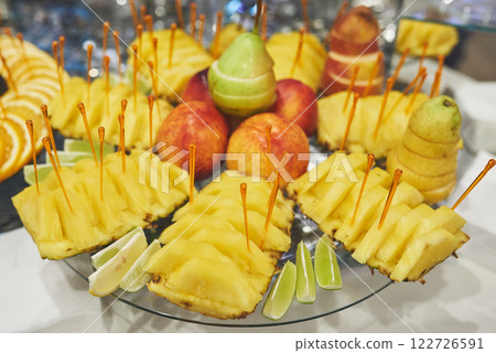 The vases with fruits stand on the buffet table 122726591