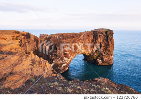 Cape Dyrholaey at southern Iceland. Altitude 120 m, and mean hill island with a door opening 122726760