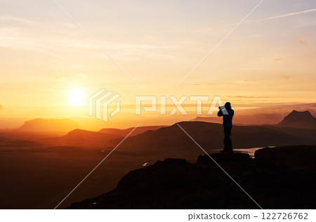 Nature photographer with digital camera on top of the mountain. 122726762