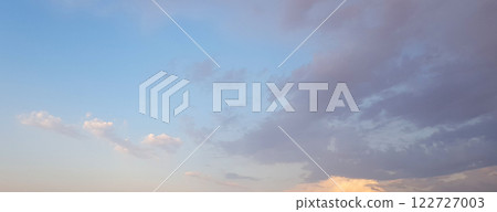 Beautiful sky, dawn background. Blue sky with gentle pastel clouds and sun light Beautiful sky, dawn background. Blue sky with gentle pastel clouds and sun light 122727003