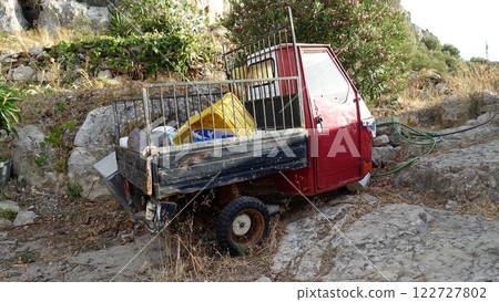 An abandoned tricycle van on a hill. An abandoned tricycle van on a hill. 122727802