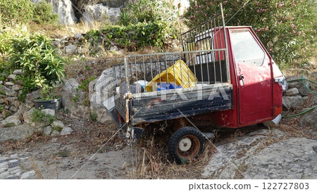 An abandoned tricycle van on a hill. An abandoned tricycle van on a hill. 122727803